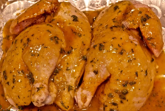 Cornish hen in pan with sauce