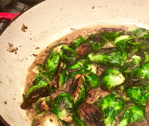 braised brussel sprouts in pan with stock