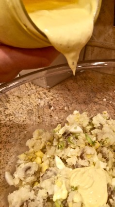 potato salad dressing being poured in