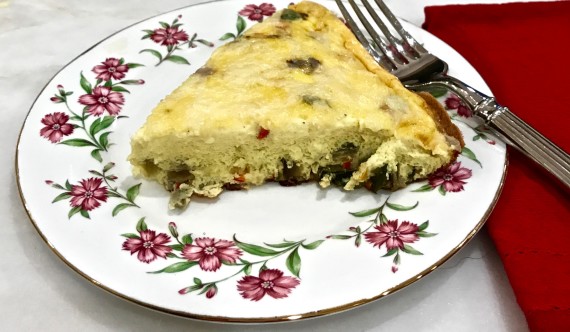 Roasted vegetable frittata cut on plate