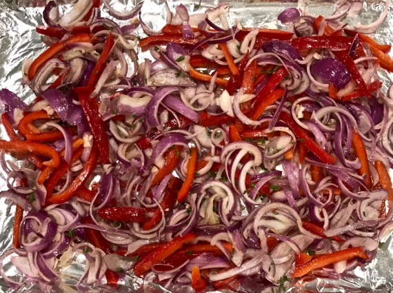 onions and peppers finished on baking pan