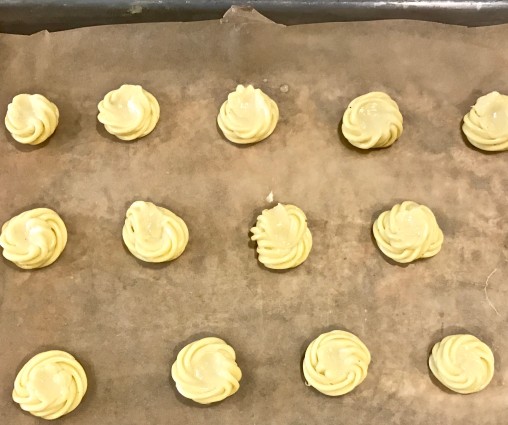 cheese puffs on baking sheet