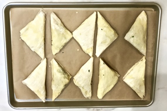 spanakopitas in pan before baking