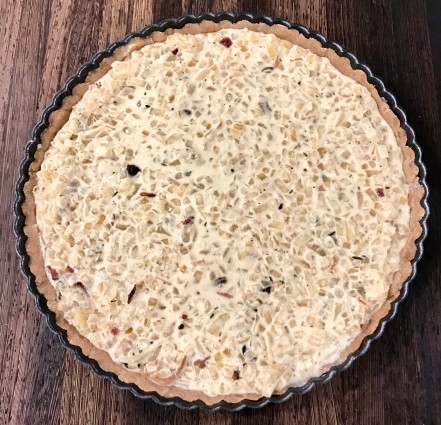 onion tart in pan with filling